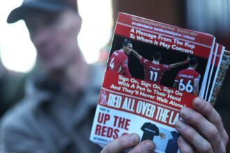 A Liverpool fanzine is seen being sold which features pictures of Virgil van Dijk, Mohamed Salah and Trent Alexander-Arnold