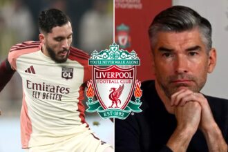 Rayan Cherki shoots the ball next to Liverpool sporting director Richard Hughes.