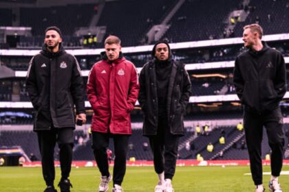 Newcastle players including Lloyd Kelly with Eddie Howe