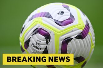 A close up image of the Premier League ball and a breaking news banner