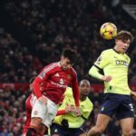 Tyler Dibling of Southampton has a headed shot deflected by Manuel Ugarte of Manchester United.