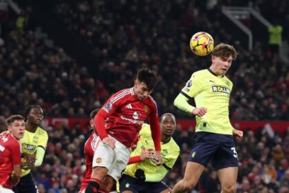 Tyler Dibling of Southampton has a headed shot deflected by Manuel Ugarte of Manchester United.