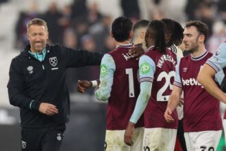 Graham Potter, Head Coach of West Ham United chats with his players