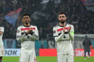 Amad Diallo and Bruno Fernandes of Manchester United applaud the fans