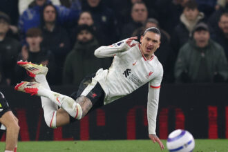 Darwin Nunez of Liverpool is hit by Emiliano Martinez of Villa
