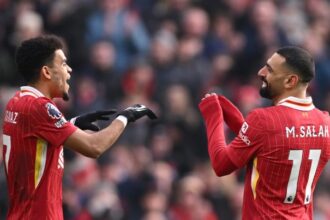 Mohamed Salah of Liverpool reacts with teammate Luis Diaz