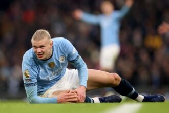 Erling Haaland of Manchester City reacts, while holding his knee