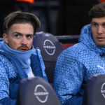 Manchester City substitutes Jack Grealish and John Stones (r) look on from the bench during the Emirates FA Cup Quarter Final match between Manchester City and Newcastle United at Etihad Stadium on March 16, 2024 in Manchester, England.