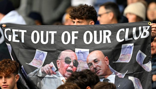 A fan of Tottenham Hotspur is seen with a flag which reads