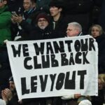 Fans of Tottenham Hotspur hold a banner which reads