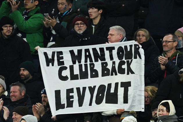 Fans of Tottenham Hotspur hold a banner which reads