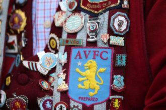 A detailed image of badges on a supporter of Aston Villa