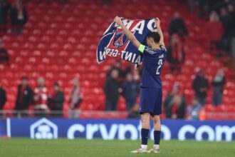 Achraf Hakimi of Paris Saint-Germain celebrates with a Paris Saint-Germain flag after the team