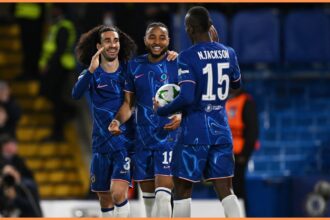 Christopher Nkunku celebrates with Marc Cucurella and Nicolas Jackson