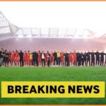 Liverpool players celebrate together after winning the Premier League title