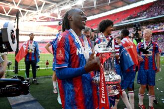 Eberechi Eze of Crystal Palace poses for a photo with the FA Cup trophy
