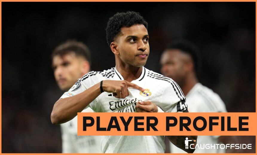 Rodrygo Goes celebrates by pointing to the Real Madrid badge on his shirt