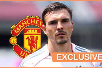 Joao Palhinha looks on in front of Manchester United club badge.