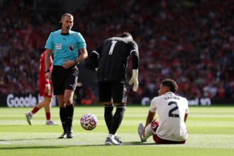 William Saliba of Arsenal reacts with an injury