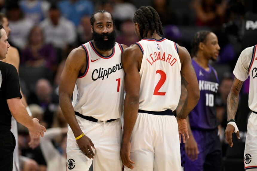 James Harden #1 of the Los Angeles Clippers and Kawhi Leonard #2 celebrate against the Sacramento Kings in the fourth quarter at Golden 1 Center on April 11, 2025 in Sacramento, California.