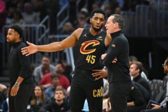 Head coach Kenny Atkinson and Donovan Mitchell #45 of the Cleveland Cavaliers looks on during the second half against the Philadelphia 76ers at Rocket Mortgage Fieldhouse on December 21, 2024 in Cleveland, Ohio.