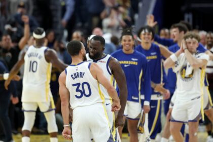 Draymond Green #2 and Stephen Curry #30 of the Golden State Warriors react after Jimmy Butler III #10 made a three-point basket against the Denver Nuggets in overtime at Chase Center.