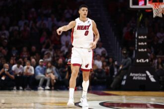 Simone Fontecchio #0 of the Miami Heat plays against the Charlotte Hornets during the first quarter of the game at Kaseya Center.