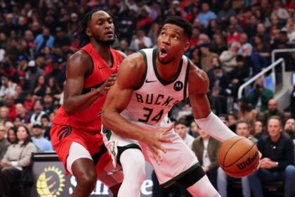 Giannis Antetokounmpo #34 of the Milwaukee Bucks controls the ball against Immanuel Quickley #5 of the Toronto Raptors during the first half at Scotiabank Arena.