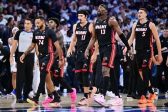 Norman Powell #24, Davion Mitchell #45, Jaime Jaquez Jr. #11, Bam Adebayo #13 and Nikola Jovic #5 of the Miami Heat walk back to the bench during a time in the first half of the game against the Orlando Magic at Kia Center.