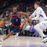 Kawhi Leonard #2 of the Los Angeles Clippers dribbles the ball around Walker Kessler #24 of the Utah Jazz during the first half of their game at the Delta Center on October 22, 2025 in Salt Lake City, Utah.