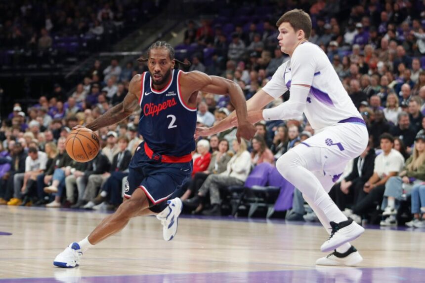 Kawhi Leonard #2 of the Los Angeles Clippers dribbles the ball around Walker Kessler #24 of the Utah Jazz during the first half of their game at the Delta Center on October 22, 2025 in Salt Lake City, Utah.