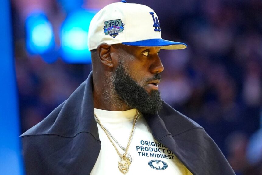LeBron James courtside wearing white baseball cap