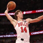 Matas Buzelis #14 of the Chicago Bulls goes up for a dunk against the Detroit Pistons during the second half at the United Center.