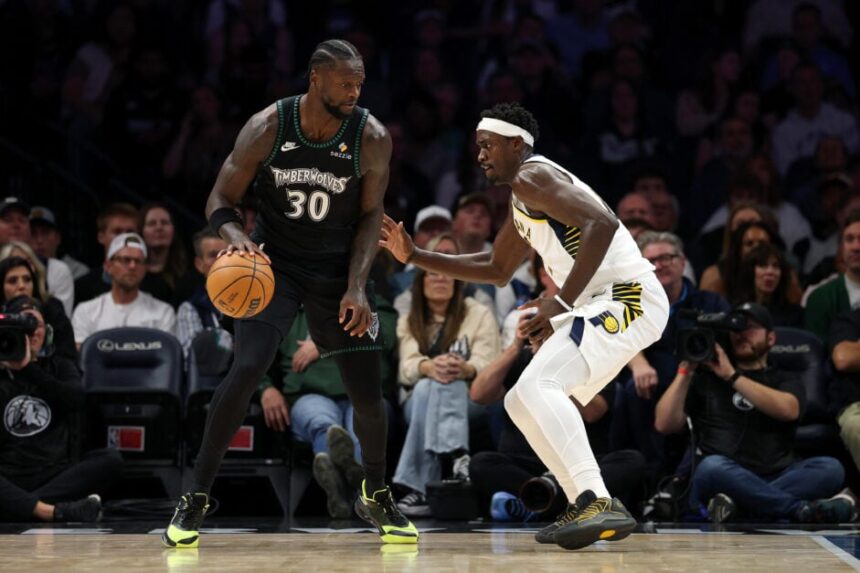 Julius Randle #30 of the Minnesota Timberwolves dribbles the ball against Pascal Siakam #43 of the Indiana Pacers.