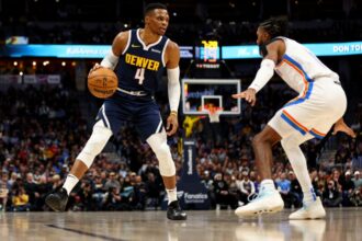 Russell Westbrook #4 of the Denver Nuggets handles the ball against the Isaiah Joe of the Oklahoma City Thunder.