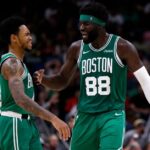 Neemias Queta #88 and Anfernee Simons #4 of the Boston Celtics reacts after scoring a three-point basket during the fourth quarter of the NBA game against the New Orleans Pelicans at Smoothie King Center.