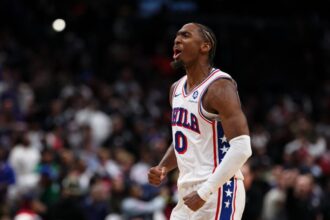 Tyrese Maxey #0 of the Philadelphia 76ers celebrates after a play against the Washington Wizards during overtime at Capital One Arena.