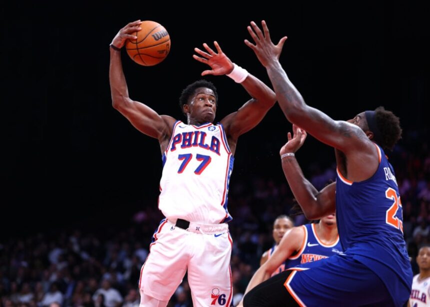 VJ Edgecombe #77 of Philadelphia 76ers drives to the basket against Mitchell Robinson #23 of New York Knicks during a preseason game between Philadelphia 76ers and New York Knicks.