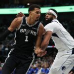 Victor Wembanyama #1 of the San Antonio Spurs is defended by Anthony Davis #3 of the Dallas Mavericks during the first half at American Airlines Center.