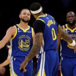 Stephen Curry #30 and Gary Payton II #0 of the Golden State Warriors celebrate in the final minute of the fourth quarter of the game against the Los Angeles Lakers at Crypto.com Arena.