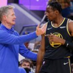 Golden State Warriors head coach Steve Kerr confers with forward Jonathan Kuminga during a game
