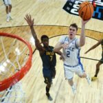 Cooper Flagg #2 of the Duke Blue Devils attempts a shot against VJ Edgecombe #7 of the Baylor Bears in the second round of the NCAA Men's Basketball Tournament at Lenovo Center on March 23, 2025 in Raleigh, North Carolina.