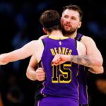 Luka Doncic #77 of the Los Angeles Lakers hugs Austin Reaves #15 of the Los Angeles Lakers looks on during the second half against the Houston Rockets at Crypto.com Arena.