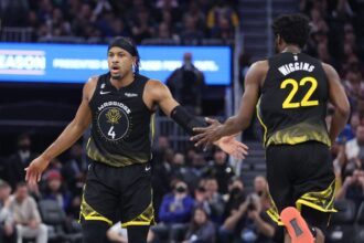 Moses Moody #4 of the Golden State Warriors celebrates a basket with Andrew Wiggins #22 in the second quarter against the Washington Wizards at Chase Center on February 13, 2023 in San Francisco, California.