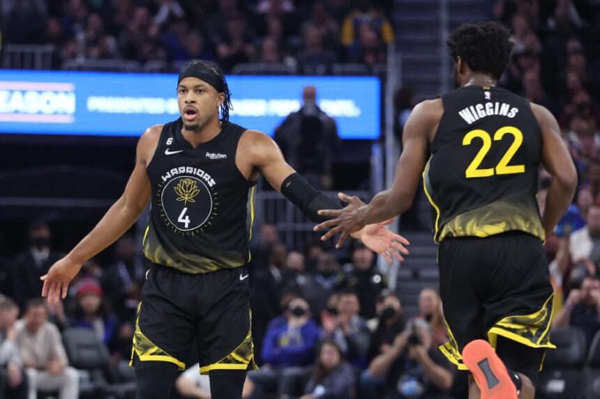 Moses Moody #4 of the Golden State Warriors celebrates a basket with Andrew Wiggins #22 in the second quarter against the Washington Wizards at Chase Center on February 13, 2023 in San Francisco, California.