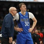 Cooper Flagg #32 of the Dallas Mavericks speaks with head coach Jason Kidd during the second half against the New Orleans Pelicans.