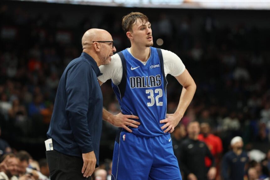 Cooper Flagg #32 of the Dallas Mavericks speaks with head coach Jason Kidd during the second half against the New Orleans Pelicans.