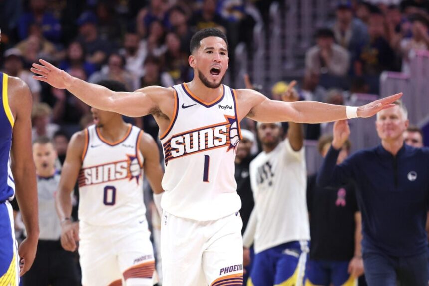 Phoenix Suns superstar guard Devin Booker complains to the referee during the Suns' game against the Golden State Warriors.