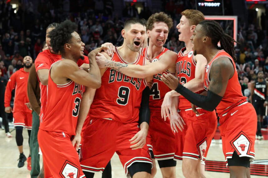 Nikola Vucevic #9 of the Chicago Bulls celebrates with teammates after making a buzzer-beating, three-point basket against the Portland Trail Blazers during the fourth quarter at the Moda Center.