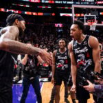 Brandon Ingram #3 of the Toronto Raptors celebrates with teammates Immanuel Quickley #5 and Scottie Barnes #4 after defeating the Charlotte Hornets at Scotiabank Arena.
